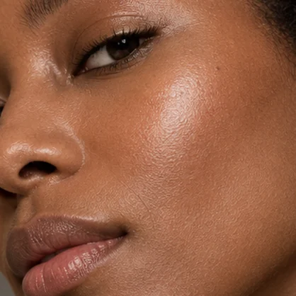 Adult woman’s cheek and lower-face skin in warm light